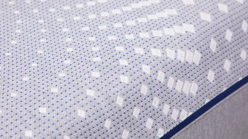 A close up view of the printed fabric on top of Sealy Posturepedic mattress.