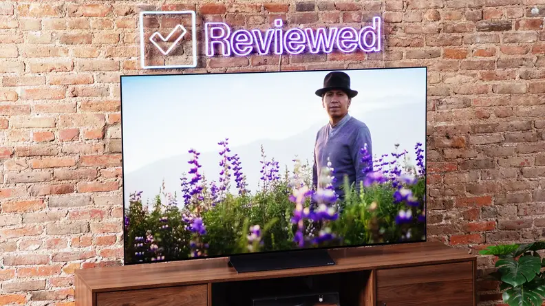 Angled shot of the LG C3 OLED TV with a man and flowers onscreen.