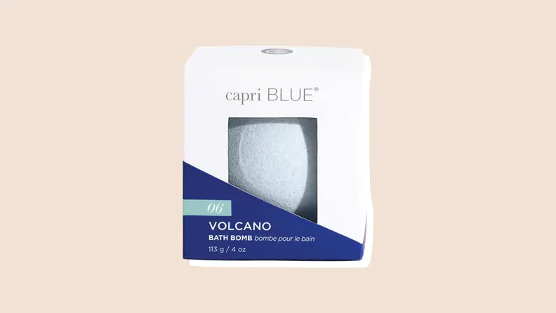 A Capri Blue 06 Volcano bath bomb in its white and blue box on a neutral background.