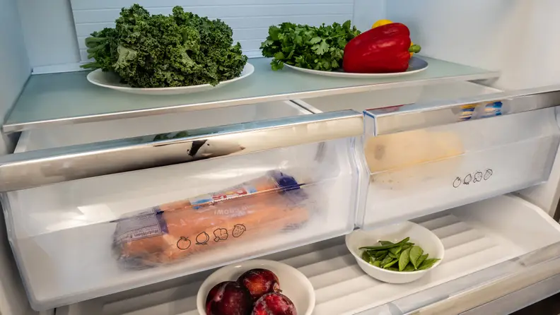 The deli drawer and crispers of the Hisense HQD20058SV French door refrigerator, stocked with items.