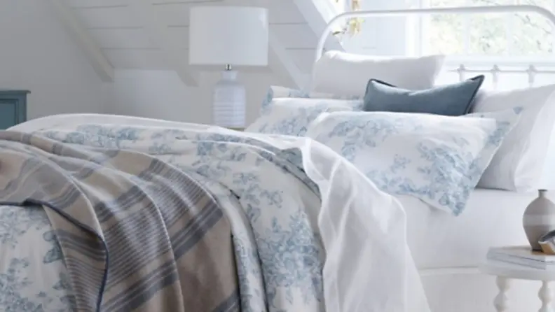 a bed made with a duvet and white garnet hill flannel sheets