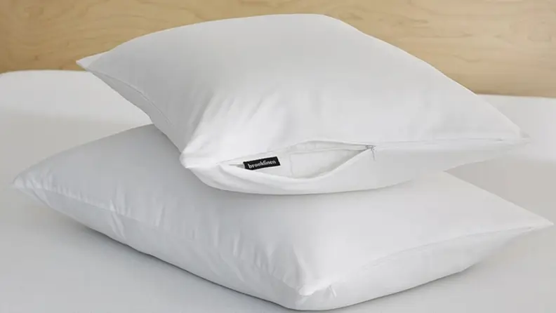 two pillows stacked atop one another with brooklinen pillow protectors