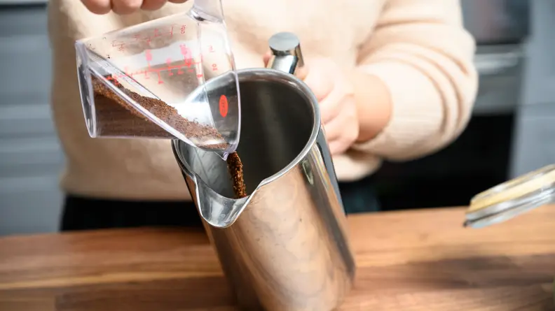 Add coffee grounds to the beaker.