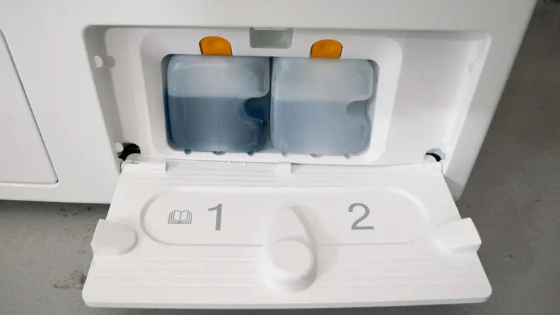 A close-up of the machine’s auto-dispensing detergent compartment.