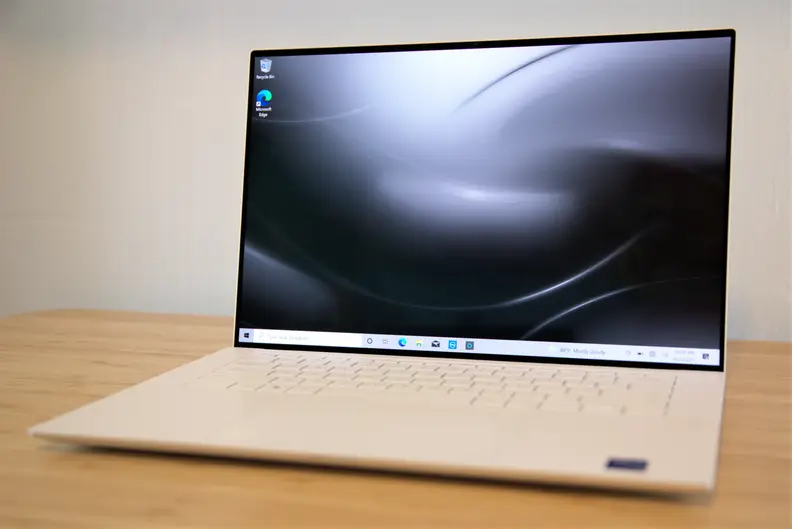 A Dell XPS 15 with OLED display on a desk.