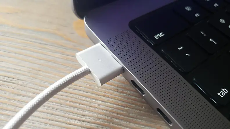 Close-up of the Macbook Pro's charger cable and port.