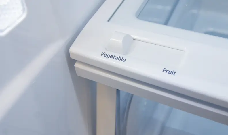A close-up of a crisper drawer's slider, with 