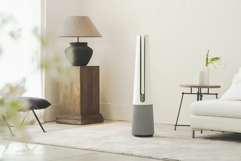 The LG PuriCare AeroTower air purifier in a brightly lit room.
