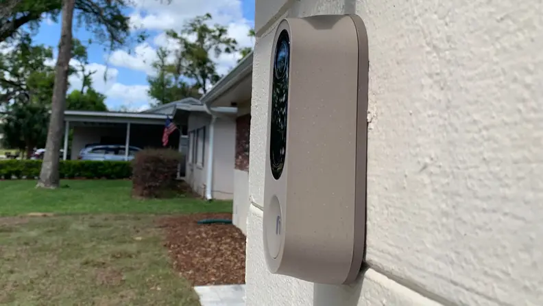 Nooie Doorbell Cam hanging on a house