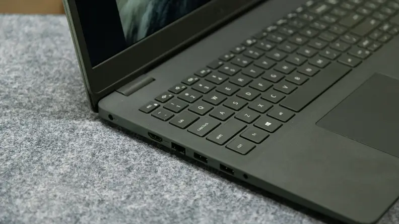 A midrange shot of the laptop's side, with the lid open