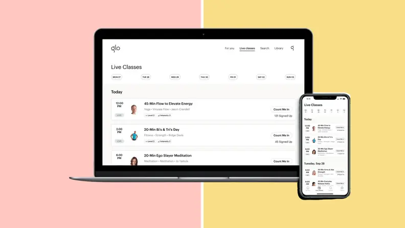 A laptop and smartphone featuring the Glo app, to do pilates at home.