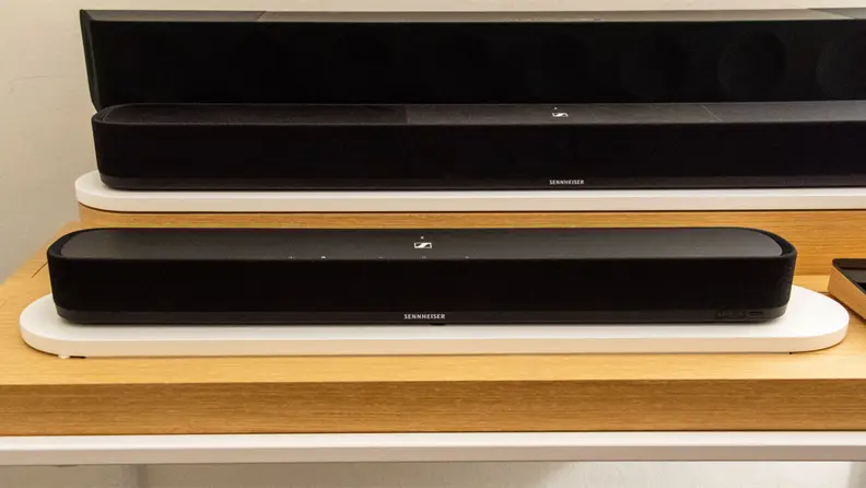 The Sennheiser Ambeo Soundbar Mini shown on a wood shelf for display.