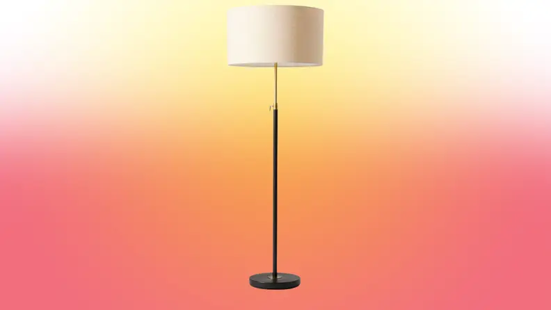 A lamp stands on a red and yellow fade background