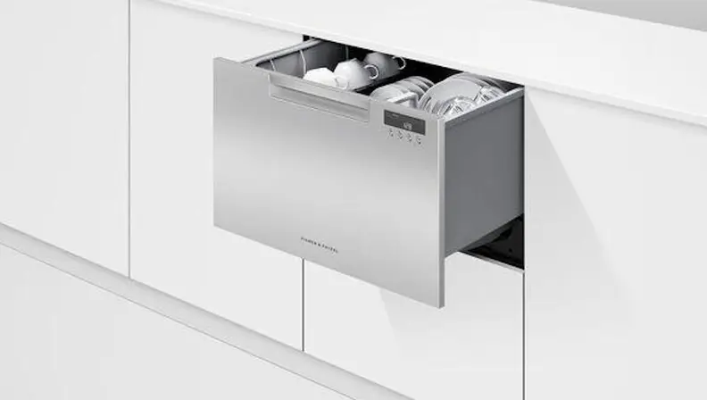 Sleek silver dishwasher hidden in white kitchen cabinetry