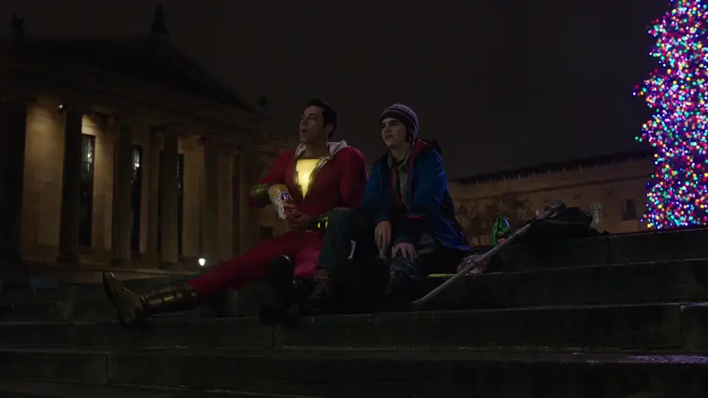 Shazam (Zachary Levi) and Freddy (Jack Dylan Grazer) watching fireworks on the steps of the Philadelphia museum of art.