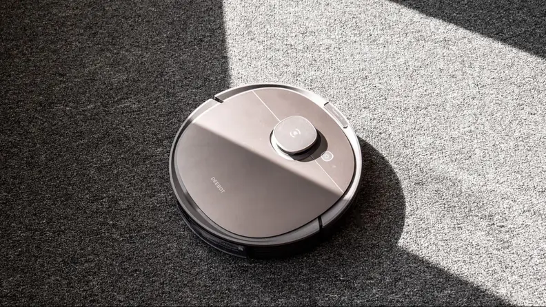 Ecovacs Deebot T8 vacuuming a sunlit room.