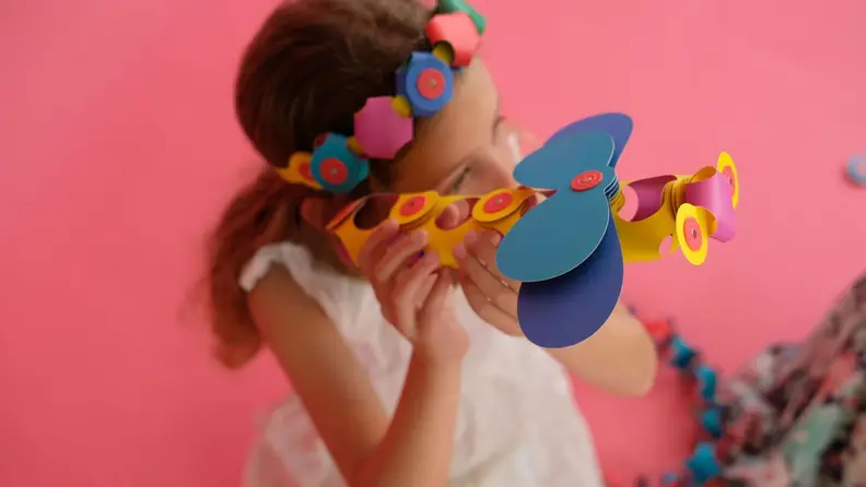 A child playing with a Clixo airplane.