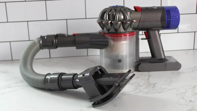 The Pet Grooming Kit hooked up to a Dyson V8 cordless vacuum.
