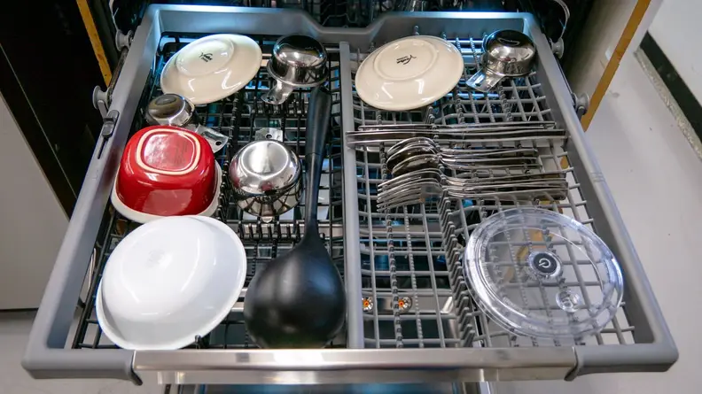 Assorted dishes and silverware sitting on third rack of LG LDTH7972S dishwasher.
