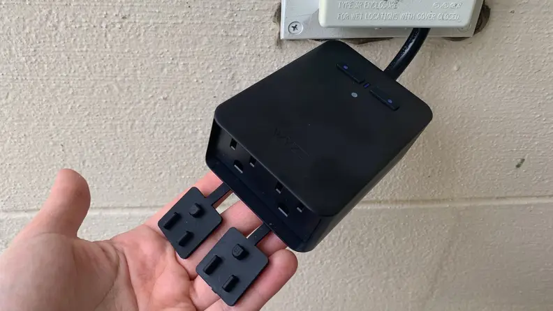 The Wyze Outdoor Smart Plug is plugged into an outside socket.