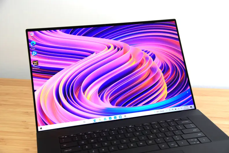 A laptop display turned on and showing off a colorful wallpaper