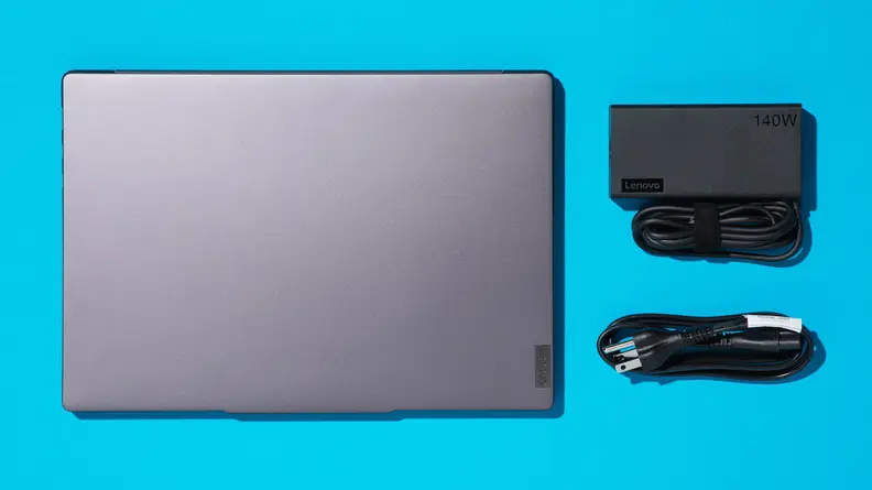 The Lenovo Slim Pro 7 next to USB charging ports on a blue background.
