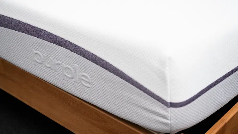 the corner of the purple mattress showing the brand's embossed logo