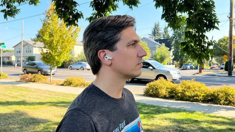 A profile shot of tester Ryan Waniata wearing the Apple AirPods Pro (second gen) in public.