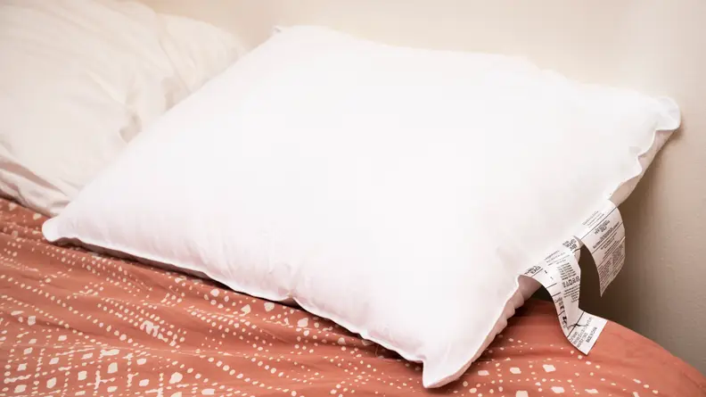 the AmazonBasics soft density pillow on a bed