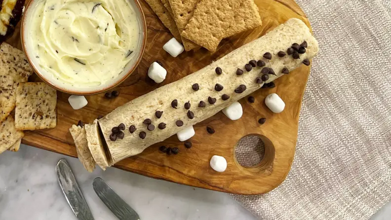 A sliced log of flavored butter on a board