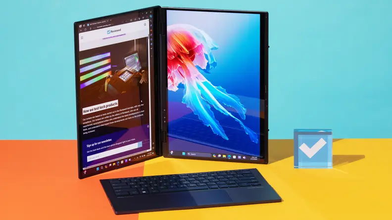 Dual screens of the 2024 Asus Zenbook Duo laptop folded upright and sitting next to keyboard and stylus pen.