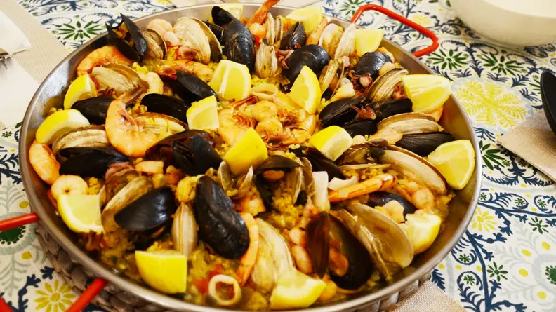You should serve paella directly from the pan.