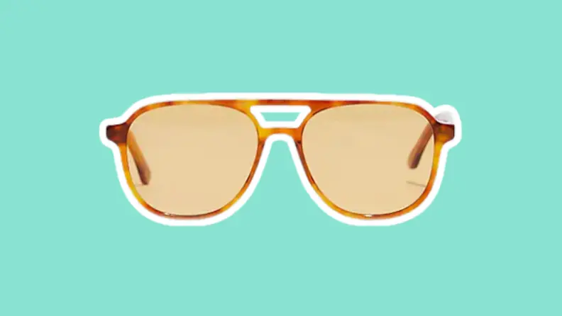The Madewell Acetate Linford Aviator Sunglasses on a green background.