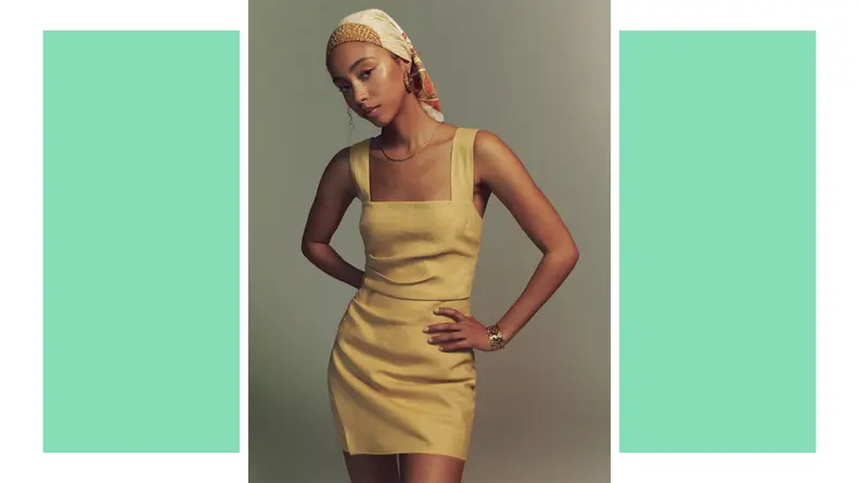 A model wears a yellow minidress.