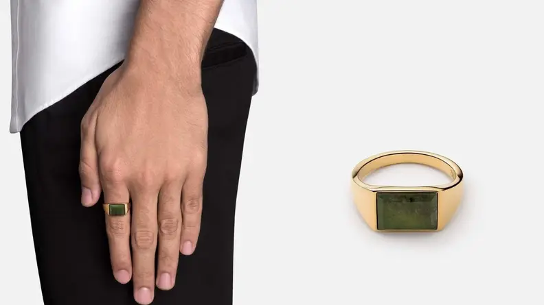 man wearing ring with hand rested to his side, gold ring with stone