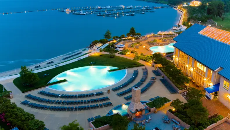 A pool and bay adjacent to a hotel