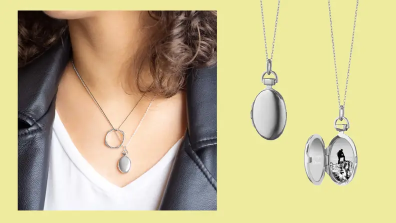 A Petite Anna Locket Necklace in silver shown open with a small image inside.