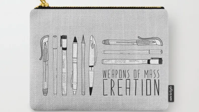 Gray pouch with gold zipper that has pens, pencils and markers printed on front. Carry all pouch also reads, "Weapons of mass creation."