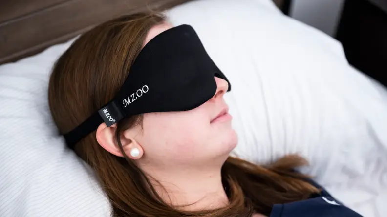 Sara sleeping in a black mzoo mask