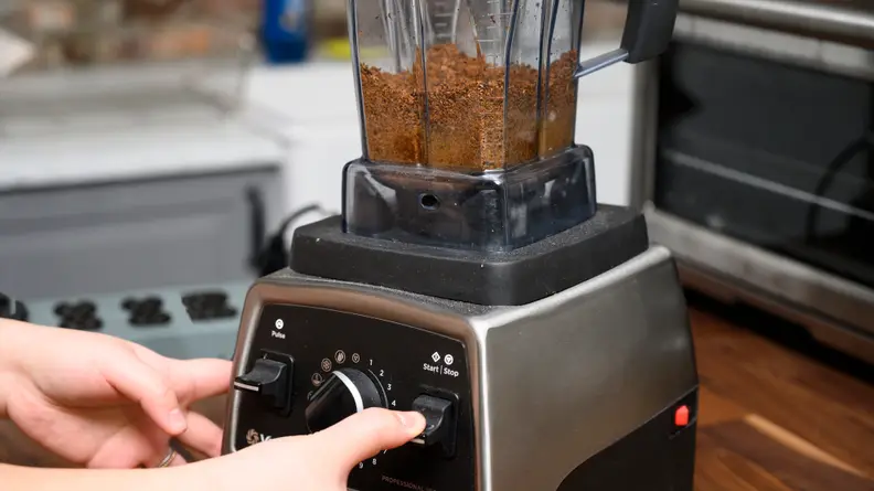 Grind the roasted hazelnuts and vegetable oil together in a Vitamix until they form a paste.