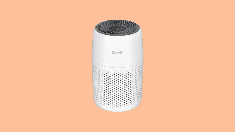 A white Levoit Core mini against a light orange background.