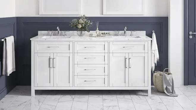 White marble bathroom sink against navy blue wall