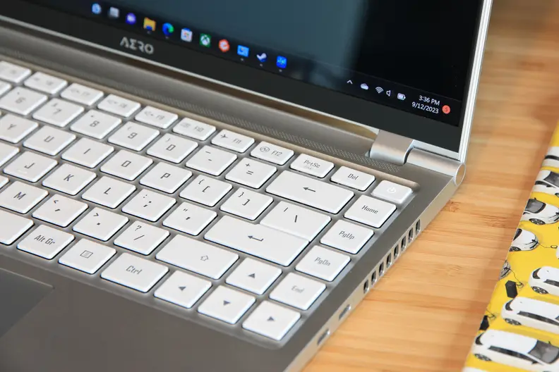 A close-up view of the side of the Gigabyte Aero 14 OLED laptop and keyboard.