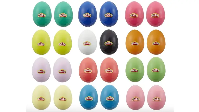 Two dozen, brightly colored Easter eggs filled with Play-doh