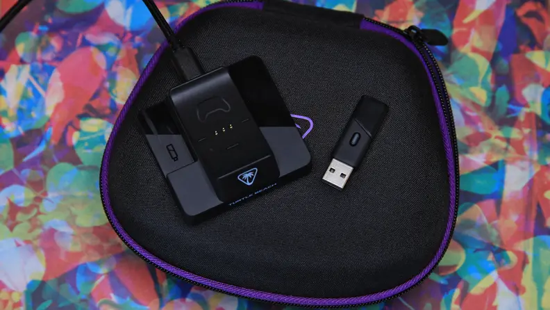 The charging station and the USB dongle laying down flat.