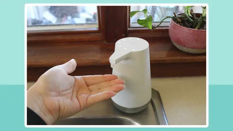 Person holding their hand under the Amazon Smart Soap Dispenser to have soap administered.