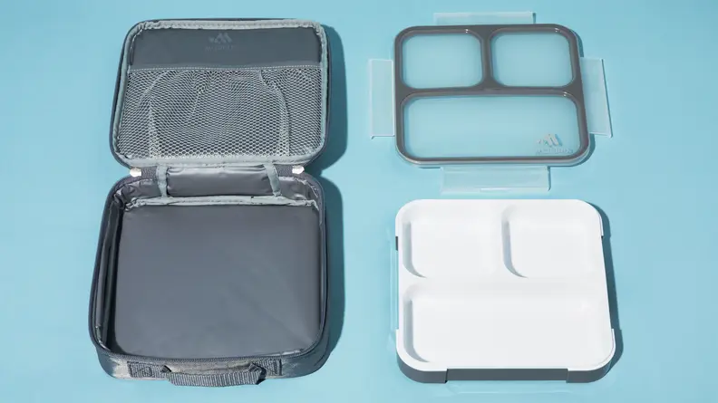 An empty Bento box sits unassembled on a surface.
