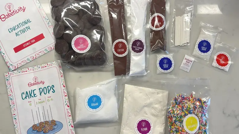 Assorted pre-measured ingredients for making cake pops arranged on a counter.