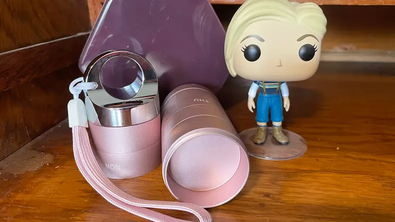 The Zannaki Metal Travel Pill Organizer next to a Funko Pop figurine