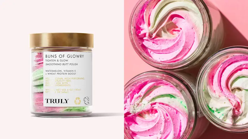 On the left: The clear jar of Truly Beauty Buns of Glowry Smoothing Butt Polish sitting on a light pink background with a pink and green polish inside it. On the right: Three jars of the butt polish are uncapped to reveal a swirl of pink and green exfoliator.